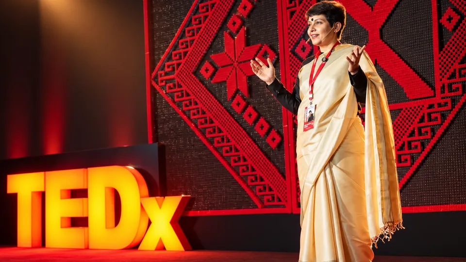 Dr Debmita Dutta speaking on stage at TEDx
